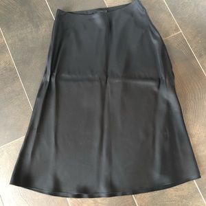 The Row black silk a line skirt.